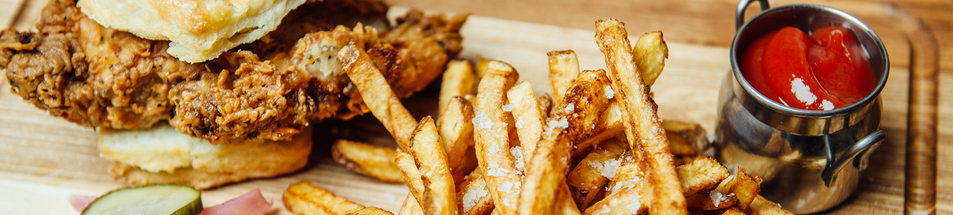 A photograph of french fries and a sandwich